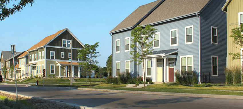 A bioswale on the side of the road in a residential neighborhood.