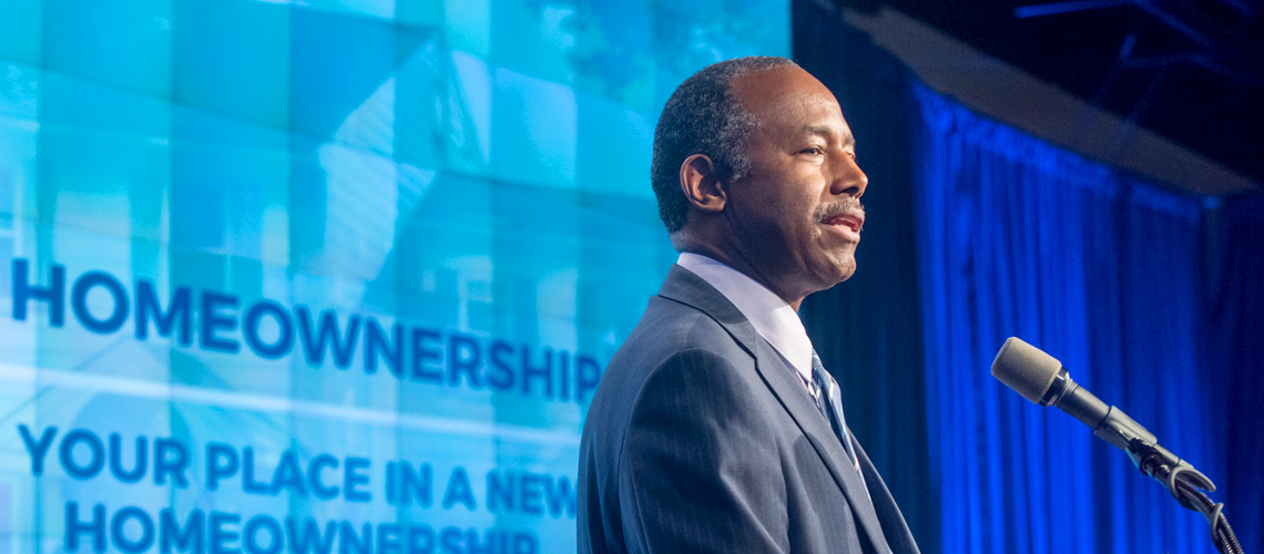 HUD Secretary Ben Carson speaks behind a podium onstage at HUD Headquarters. Featured article