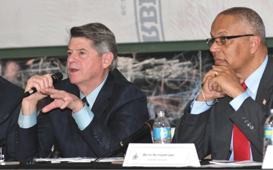 Maryland Department of Housing and Community Development Secretary Kenneth Holt and Lieutenant Governor Boyd Rutherford seated next to each other answer audience questions at a meeting.