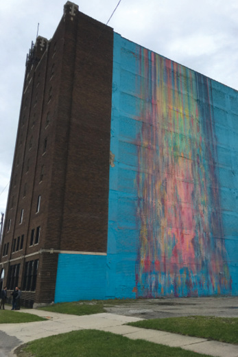 Photo shows front and one side of a nine-story building.