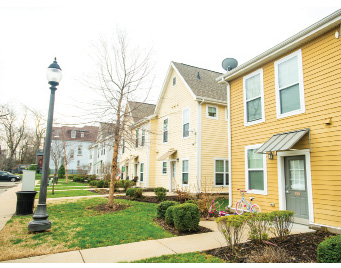 A row of single-family houses with small front yards.