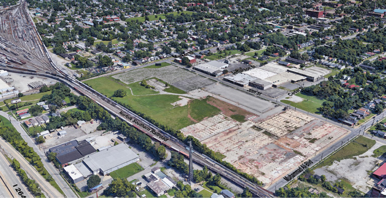 An aerial view of a Louisville, Kentucky, showing railroad tracks, vacant sites, and neighborhoods.