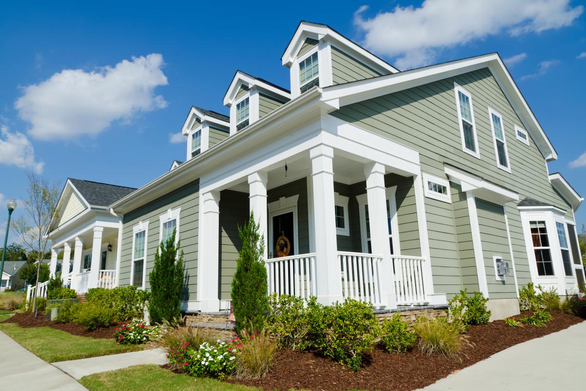 Photo shows front and side facades of a single-family home.