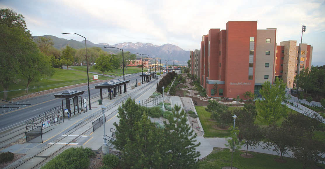 Multifamily buildings located along a multimodal street with bus, rail, and bike paths.