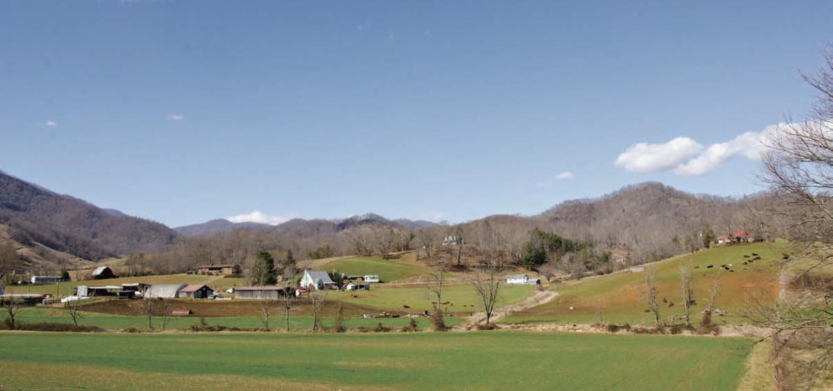 A panoramic view of a farming community with hills in the background in Western North Carolina.