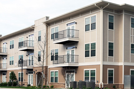 Photograph of the façade of a three story residential building.