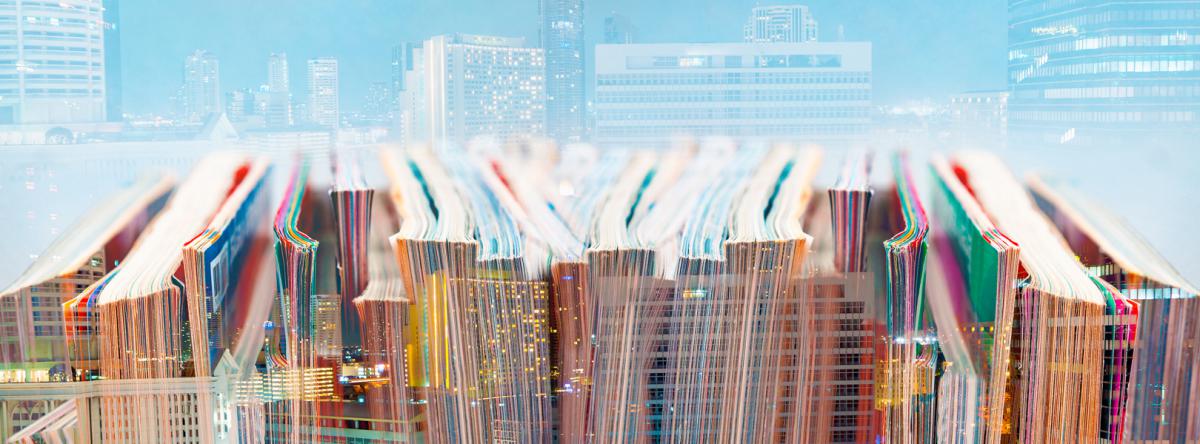 Magazines with light blue background of a cityscape.