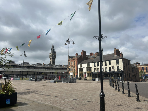 Town center market and plaza, with clock tower in the background.