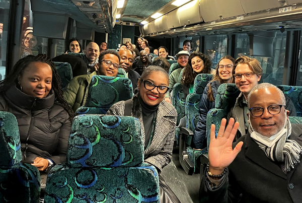 CHA staff, HUD leadership, and students sitting on tour bus.