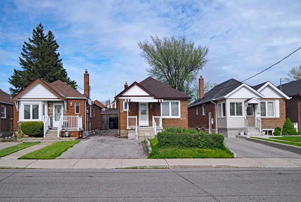 Photo of a street with a row of houses.