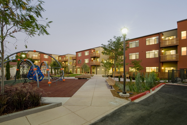 Apartment buildings with a playground to the left.