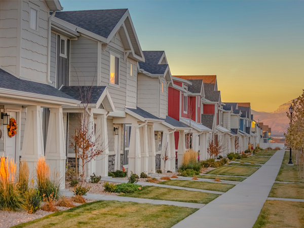 Photo of townhomes with a sunset in the background.