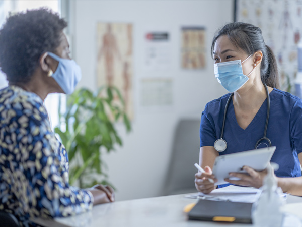 Photo of a doctor speaking with a patient.