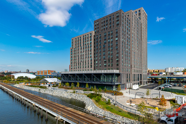The Bronx Point building, with the Harlem River in the foreground.