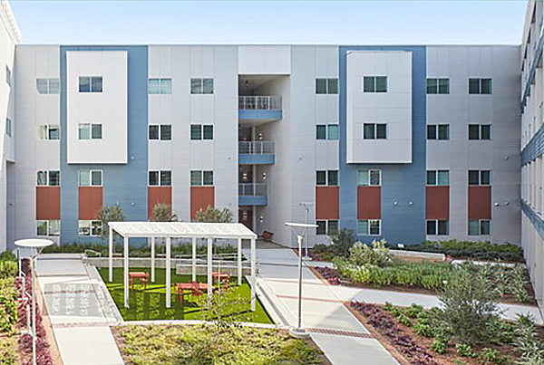 Landscaped courtyard with a residential building in the background.