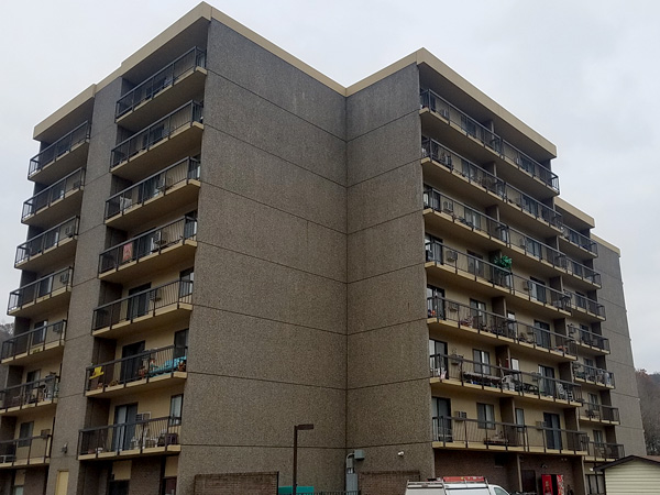A tall, concrete apartment building.