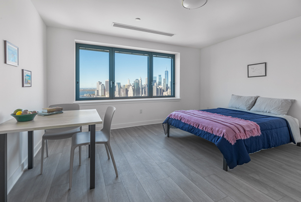 A studio apartment interior with sprawling city views.