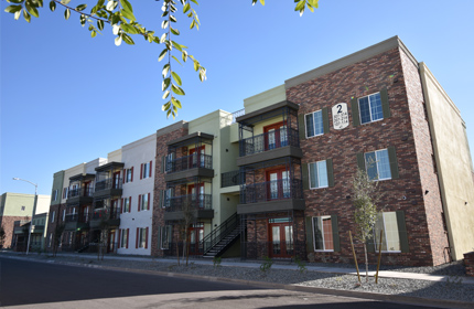  A walkup three-story building with balconies.