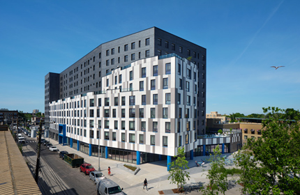 A large gray and white apartment building.