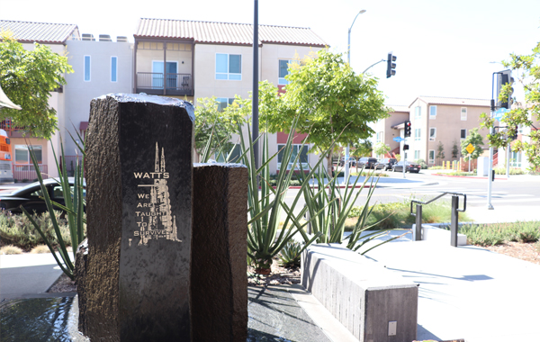 Picture of “Watts” plaque with residential units across the street.