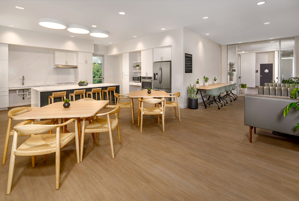 Image of a community kitchen and common area in an apartment building.