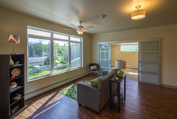 Image of an apartment living room with a view of landscape.