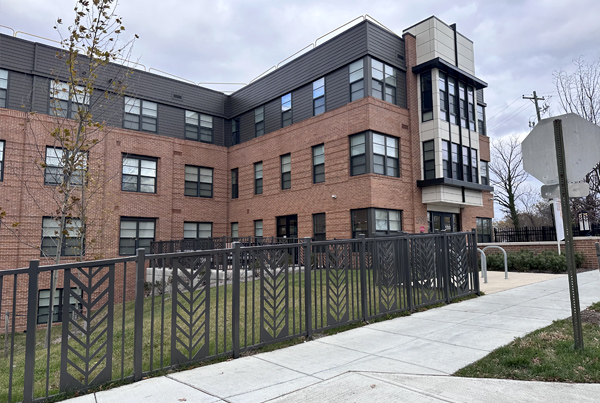 A four-story brick apartment building.