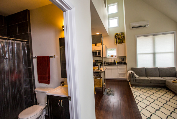 Interior of a cottage with bathroom, living area, and a portion of the kitchen.