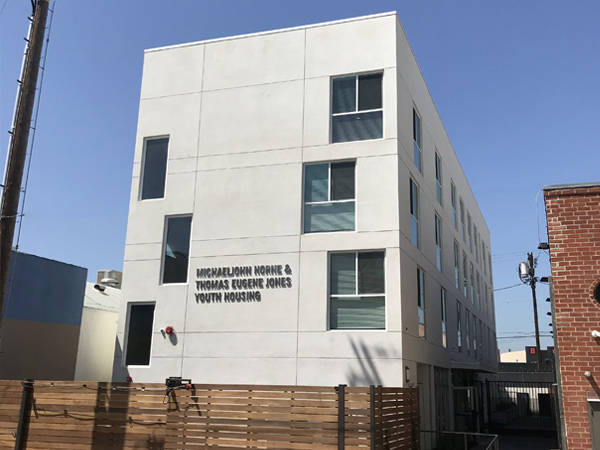  Image of a four-story apartment building.