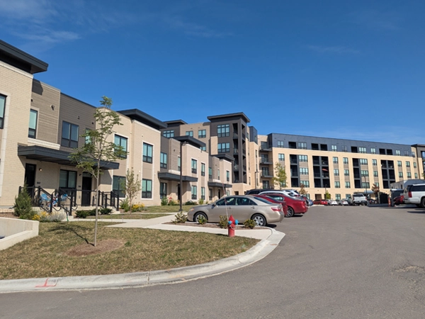 Exterior of townhouses and a five-story apartment building.