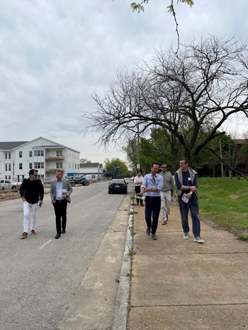 Group of people touring the Preservation Square public housing project.