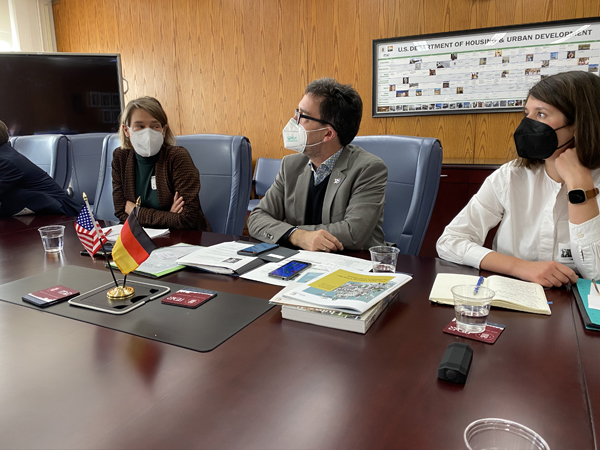  Photo of four people sitting in front of a large table.