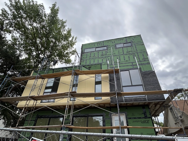A house under construction, surrounded by scaffolding.