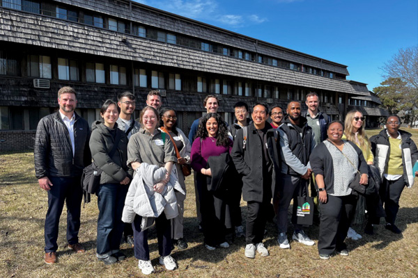 CDA staff, HUD employees, and students in the courtyard during site tour of the CDA-owned property.