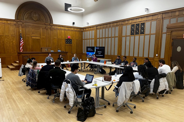 Student meeting with local affordable housing stakeholders and experts during a panel discussion on public housing repositioning, funding, and tax credits.