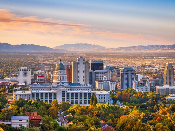 A panoramic view of Salt Lake City at sunset, showcasing a vibrant cityscape.