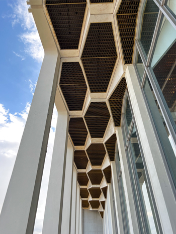 Picture looking up at hexagonally coffered ceiling of a performance hall portico.