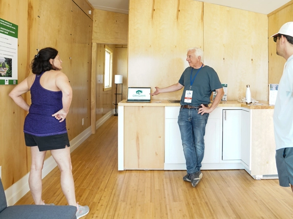 A group of people inside a model house.