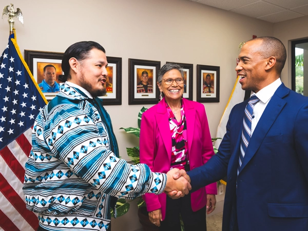 HUD Secretary Scott Turner shakes hands with a representative of the
Seminole tribe at the Native Learning Center