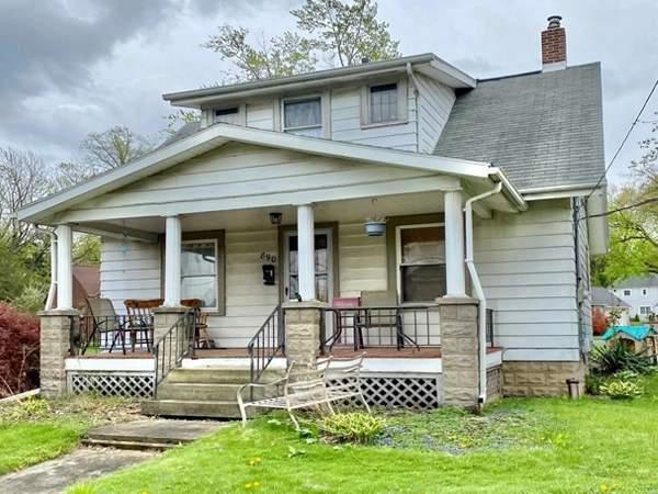 A 1925 Arts and Crafts style Sears Marina bungalow kit home, with a yard in front.