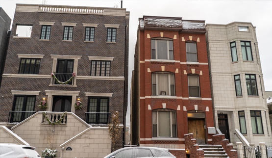 Photograph of the front façades of three residential buildings.