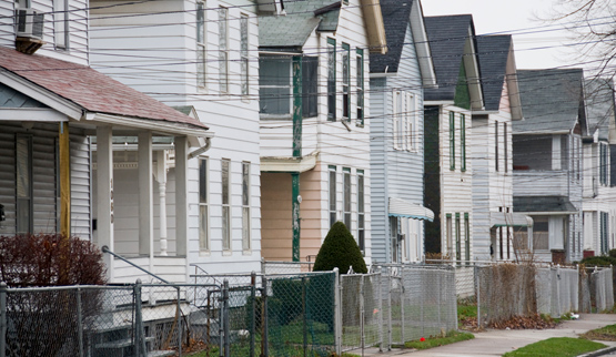 Photograph of the front façades of several two-story, single-family detached houses.