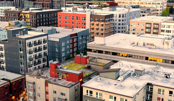 Low-angle aerial photograph of midrise buildings.