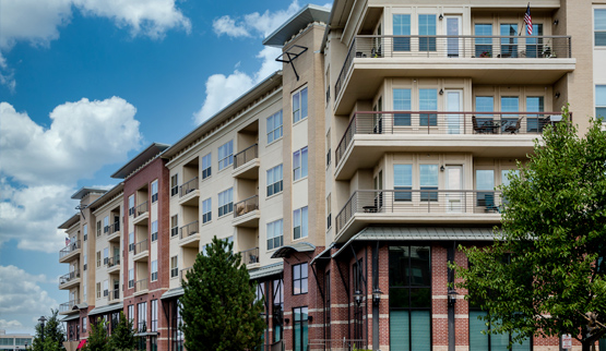 Photograph of two façades of a multistory residential building.