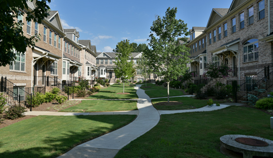 Two-story townhouses arranged around an openspace.