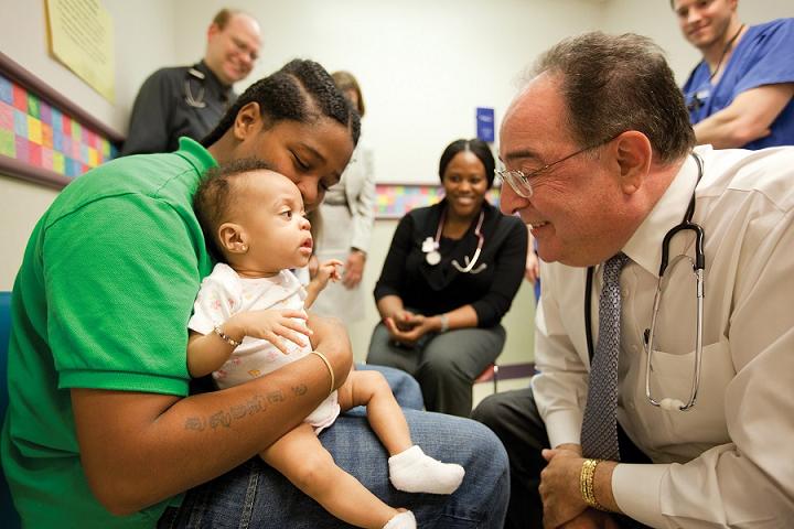As part of the university’s Interprofessionalism Education initiative, Jay A. Perman, UMB’s president and a pediatric gastroenterologist, joins students from all UMB schools in team-based care of young patients at the University of Maryland Medical Center (courtesy of University of Maryland, Baltimore).