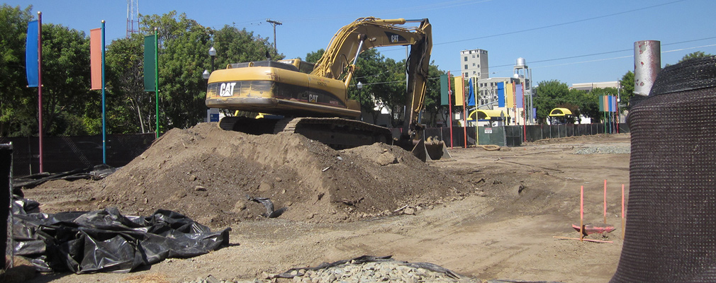 Photograph showing an excavator at the La Valentina site prior to construction.