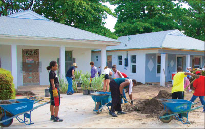 Homebuyers and volunteers provide sweat equity and labor to build Habitat for Humanity homes in Miami, Florida.