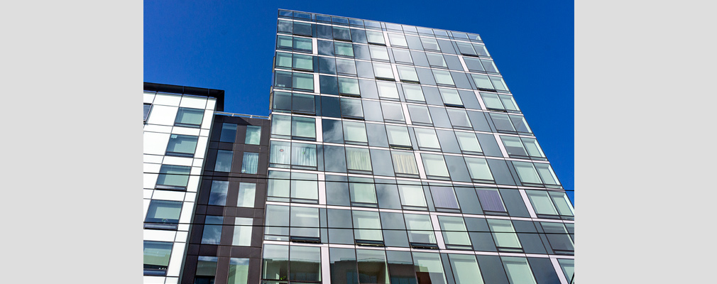 Photograph of the upper seven stories of a highrise building.
