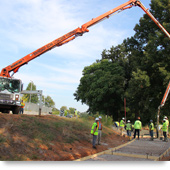 A photograph shows a truck pouring concrete to form the path along a portion of the Westside Trail.